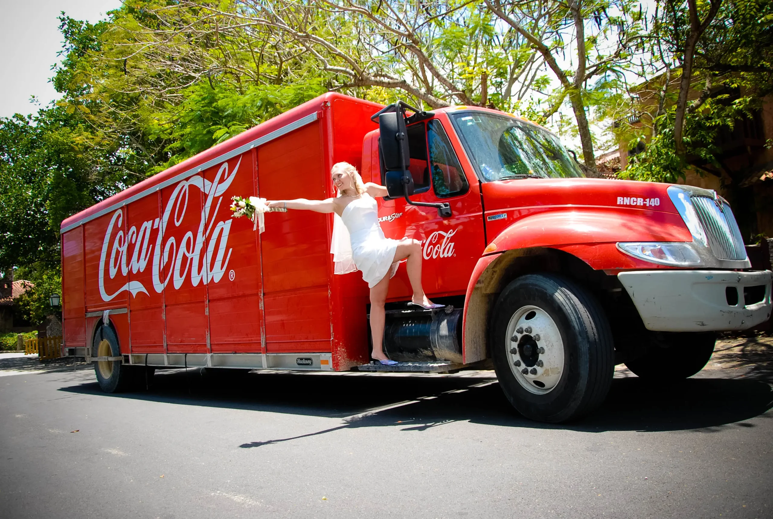 Image of a woman dressed as a groom posing in a truck